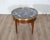 A refined French Louis XVI-style bouillotte coffee table, early 20th century, crafted in rich mahogany with elegant...