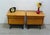 1960s set of two bedside tables, each with one drawer and a drop-down door, in ash veneer with black accents, from the...
