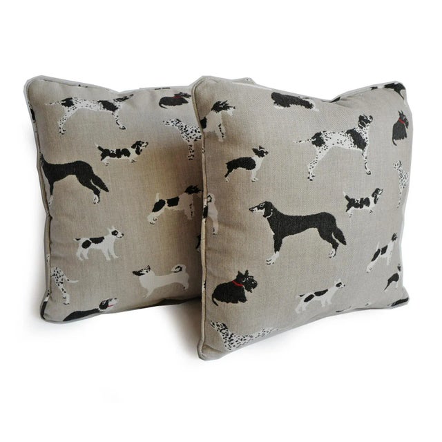 Celebrate man's best friend with this charming outdoor accent pillow featuring an assortment of classic dog breeds on a...