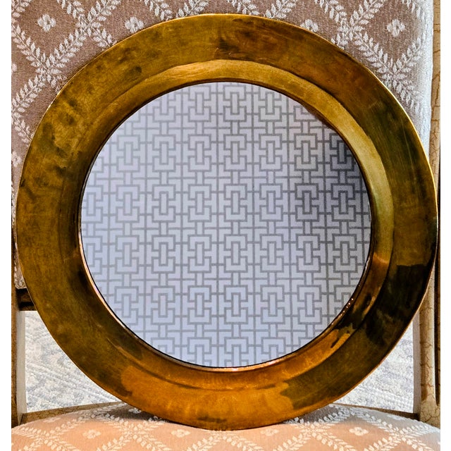 Elevate your wall décor with this striking vintage round mirror by Design International of Oakland, California,...