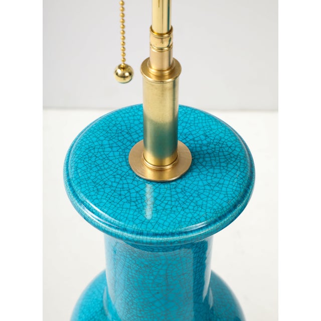 Stunning pair of ceramic lamps with a Cerulean blue crackle glazed finish by Paul Hanson. The lamps have been Newly...