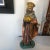 Colorfully hand painted ceramic royal figure holding a communion box in a soft patina finish. Hand made items may vary in...