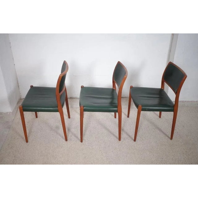 For sale are three classically beautiful teak model 80 chairs by Niels Otto Moller. They are covered with dark green...