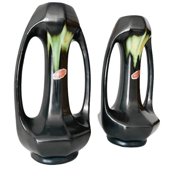 Antique Thulin Art Nouveau vases, made of matte black ceramic with a green drip glaze, circa 1910, in a typical Art...