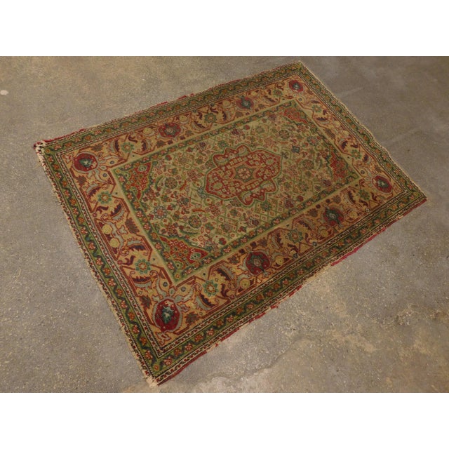 Geometric central medallion on a beige field, decorated with Herati pattern. Salmon border decorated with turtle motifs....