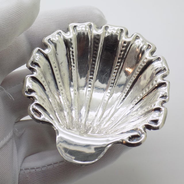 An elegant vintage object depicting a small raised bowl in the shape of a shell, handcrafted in Palermo, Sicily, Italy...