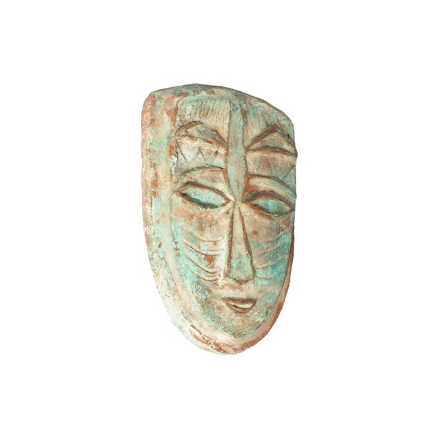 A studio pottery plaque by American artist Edna Reindel (1894-1990). This work depicts a mask-like face featuring...