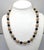 1960s single strand alternating goldtone ovoid filigree beads with black cut glass beads with small smooth spherical...