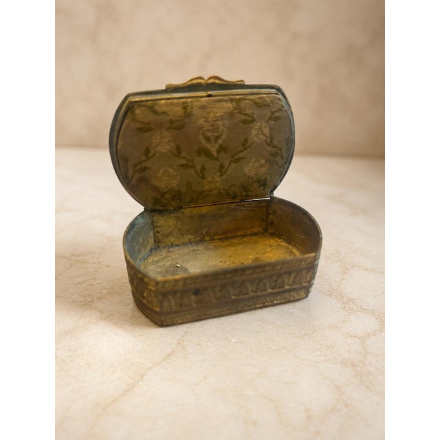 A charming antique bronze casket box with a beautifully aged silk-covered lid panel and a delicate hand-painted portrait...