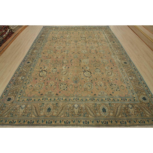 An authentic vintage traditional Tabriz rug hand-knotted with fine wool and natural dyes. This oriental rug features an...