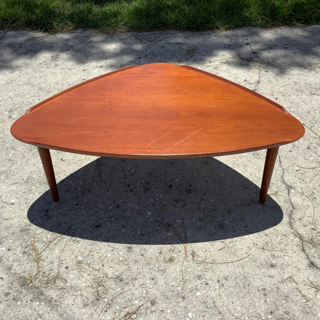 1950's Danish Mid Century Modern Teak Triangular Coffee Table by William Watting. Solid teak with curled edges, triangular...