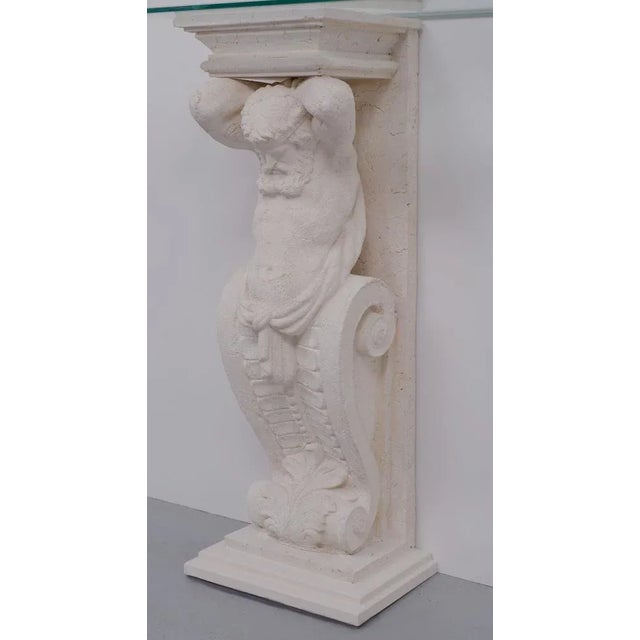 Two unique Cast Stone console tables, mythologies Greek manly figures carries a beveled Glass top, so very decorative.