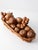 Set of mid century carved wood fruit including apples, grapes, pears, and assorted forms in varied warm wood tones. The...