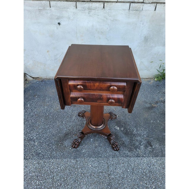 This elegant 19th century Mahogany Empire drop leaf nightstand showcases the timeless appeal of the Empire style. Crafted...