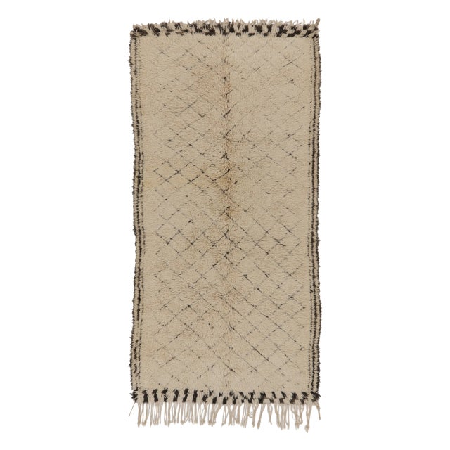 Handwoven in wool circa 1950–1960, this 6x13 vintage rug features an elegant ivory field with subtle charcoal lattice...