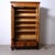 Beautiful wooden display bookcase, from the late 19th century, with two doors and highly original glass with a slightly...