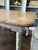Rustic farmhouse table with natural scrubbed pine, fluted legs, distressed in white. Early 20th Century, used as a kitchen...