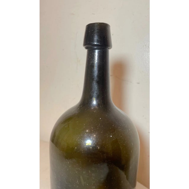 Up for sale is a large antique 19th century hand blown glass demijohn wine bottle. It's blown by hand out of thick green...