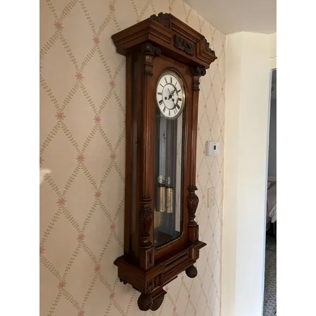 Beautiful Vienna vintage 19th century period carved mahogany wall clock with two heavy brass weights. Chimes on the hour...