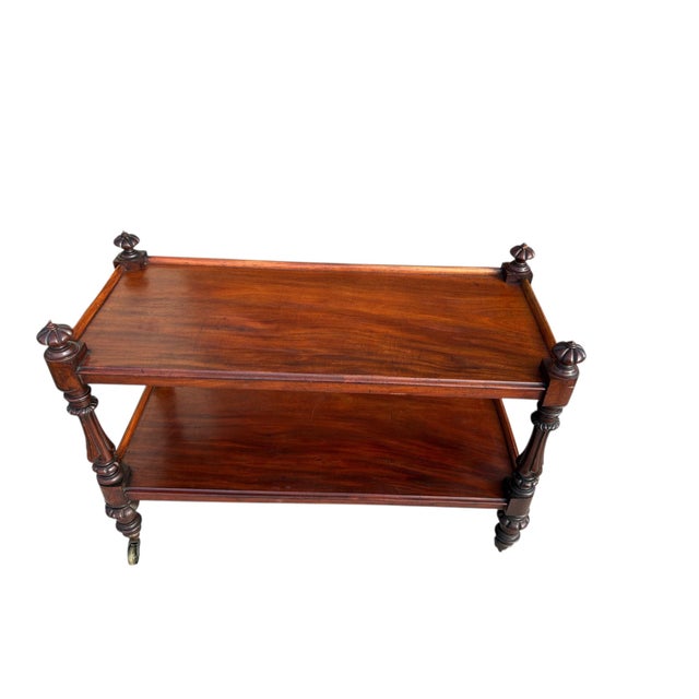 An unusual sized English trolley from the middle of the 19th century. The carved mahogany is rich in color and has two...