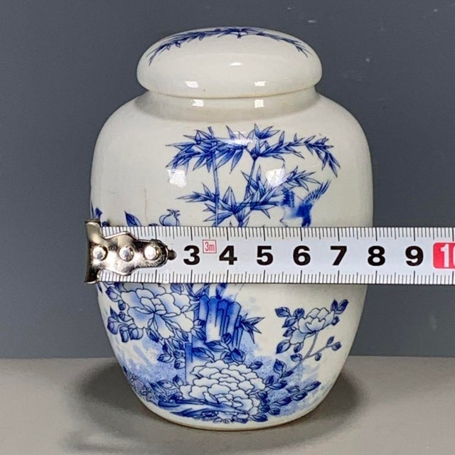 A charming Chinese blue and white porcelain covered jar. The white ground is hand-painted in underglaze blue with a lively...