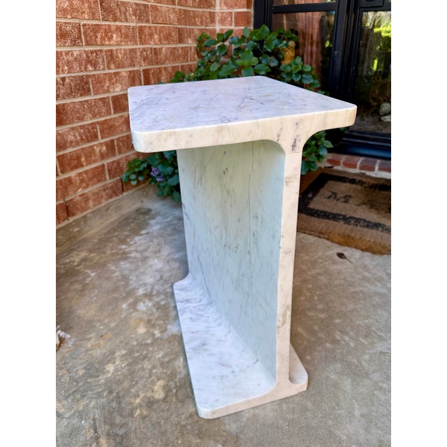 ⸻ Solid Marble Side Table / Pedestal This striking side table is carved from a single block of solid marble, featuring a...