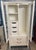 White Thomasville Allegro faux bamboo armoire features brass hardware. Freshly painted white, this cabinet has glass doors...