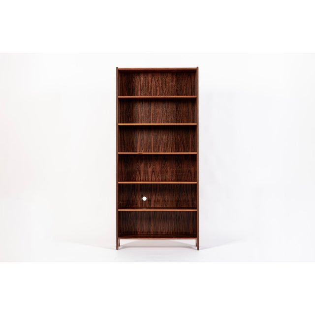 This exceptional vintage mid century Swedish modern rosewood bookcase was made in Sweden circa 1960. The minimalist design...