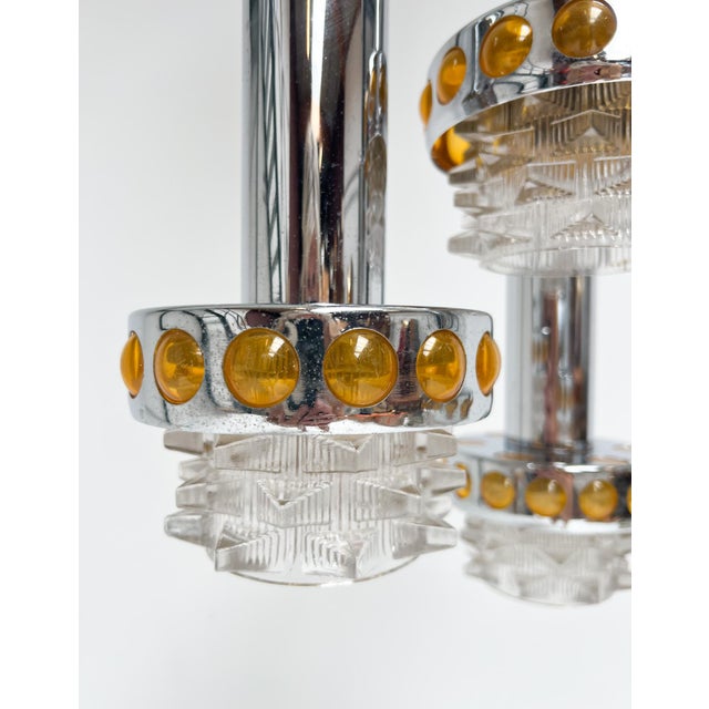 Unique Cascade chandelier by Raak from the 1970s. This lamp with 4 light points. The glass holders are made of chrome with...