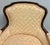 Beautiful vintage French-style bergère armchair featuring a graceful carved wood frame and classic curved silhouette....