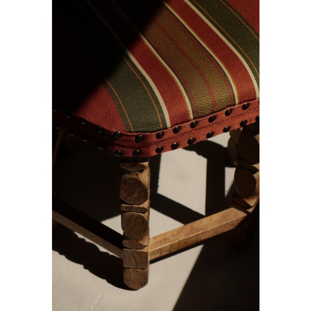 A sculptural Danish modern stool crafted in solid oak with beautifully turned legs and stretcher base, executed in the...