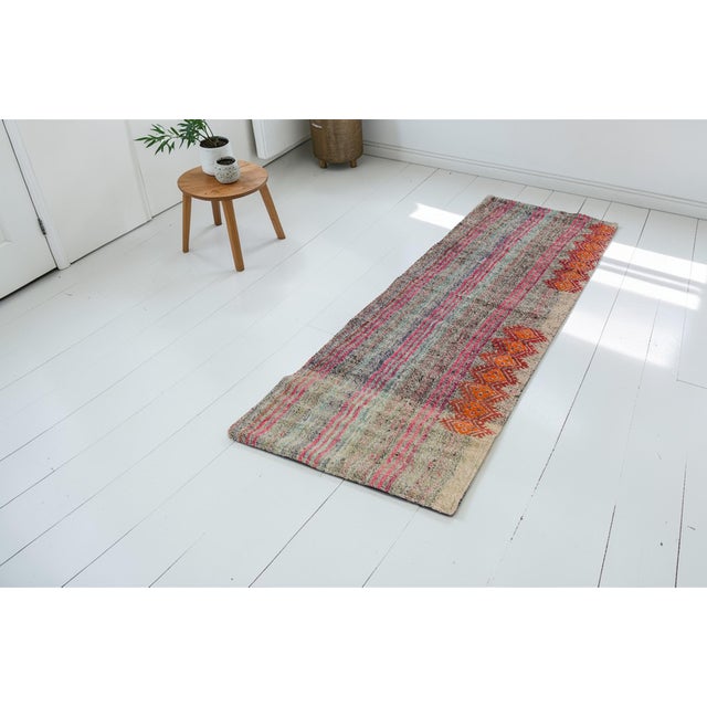 This is a vintage Turkish Oushak rug from the Mid 20th Century. The piece was hand-knotted.