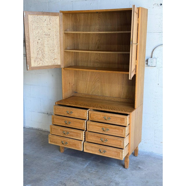 Beautiful vintage Danish hutch cabinet in style of Henning Kjærnulf and crafted in oak. This elegant Scandinavian cabinet...