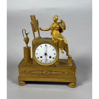 Empire period 19th century mantel clock depicting a woman at her toilette For Sale