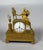 Empire period 19th century mantel clock depicting a woman at her toilette For Sale