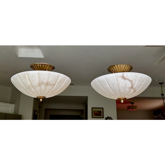 A matching pair of mid-century French Directoire-style semi-flush mount ceiling lights, crafted from solid natural white...