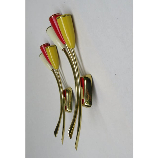 1 pair of wall lights, 50s, 3-bulb, Italy, made of brass, Bakelite painted beige, red and yellow The lights each have 3...