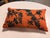 Design Plus Gallery presents a Decorative Lumbar Pillow. This is an orange decorative pillow adorned with embroidered...