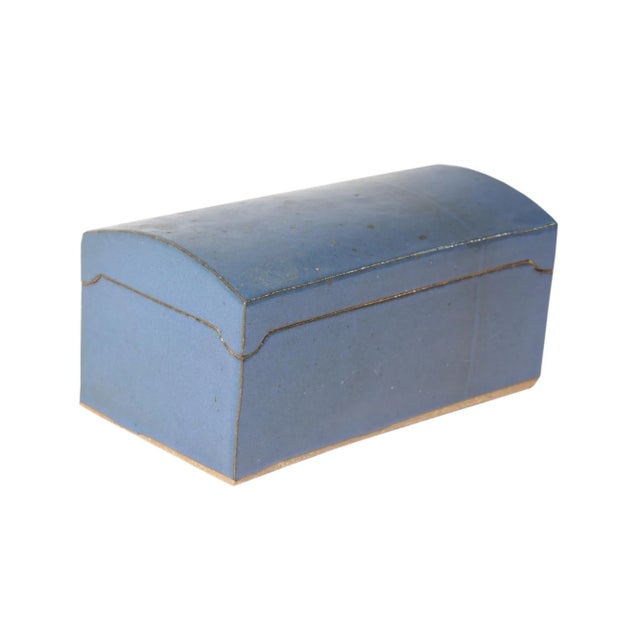A studio pottery box by Indiana ceramic artist Dennis Kirchmann (1939-2017). The lidded box has a solid blue glaze and has...