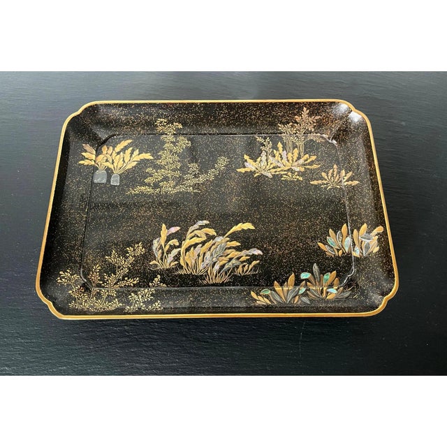 A lovely Japanese lacquer rectangular lacquer tray with a slightly scalloped corner and four L shape supporting feet by...