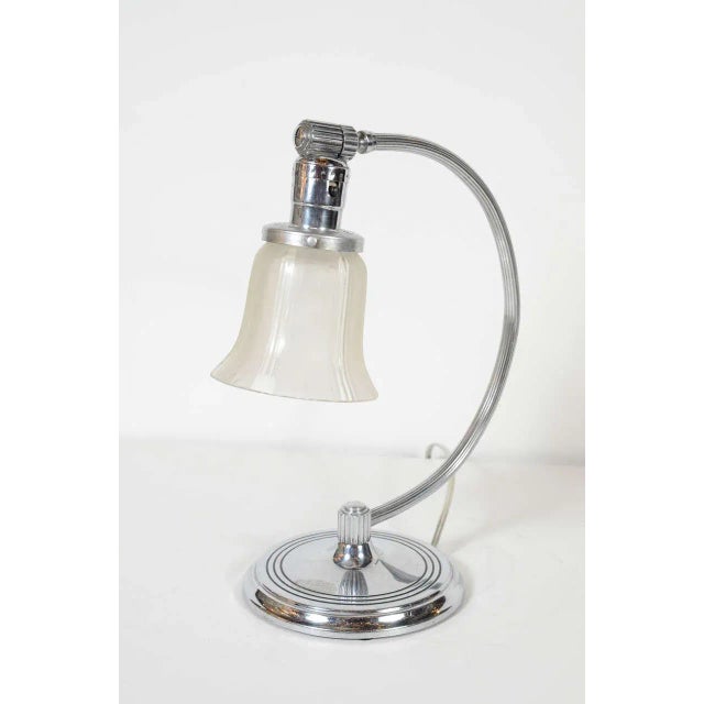 This gorgeous Art Deco Machine Age table lamp has an adjustable frosted glass shade on a chrome arc base with concentric...