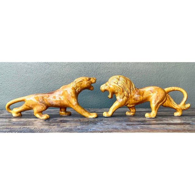 Unleash the wild side of your decor with this striking pair of vintage ceramic stalking lions. Channeling the bold spirit...