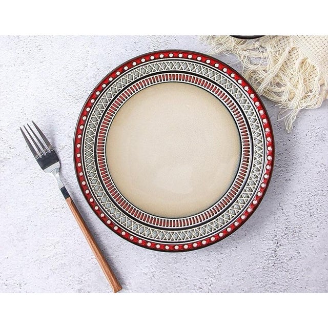 Employing handmade underglaze painting or relief techniques, the plate is decorated with multiple layers of ethnic-style...