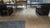 Rectangular walnut coffee table featuring a low-profile silhouette and sculptural block base formed from intersecting...