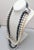 1980s rhodium plated 3-strand faux-white, light grey and dark grey baroque pearl necklace with raised square hook clasp....