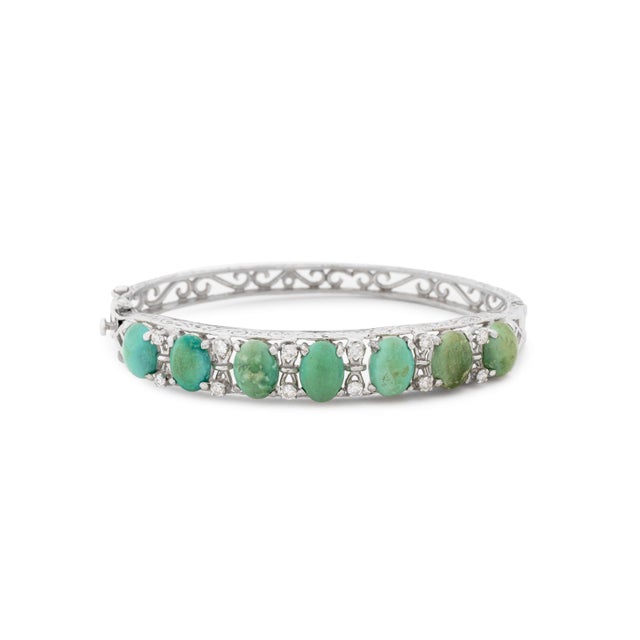 14K White Gold Turquoise Diamond Bangle, adorned with 7 prong set turquoise cabochons weighing a total of approx. 7.00...