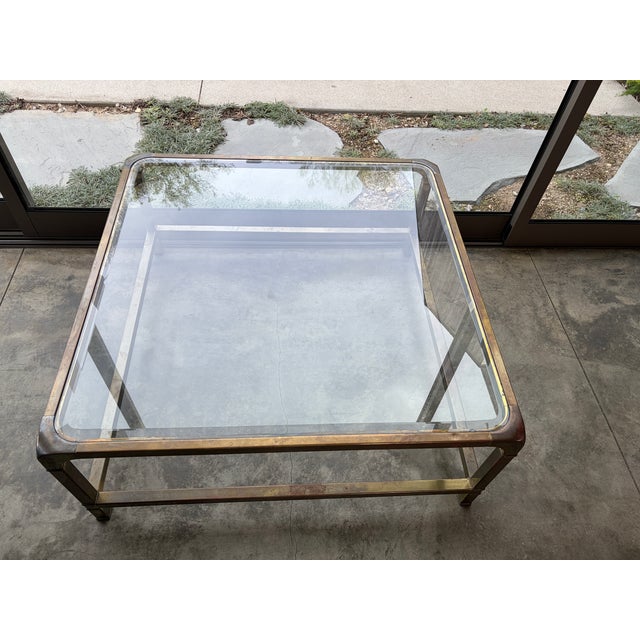 A timeless, chic brass and glass coffee table, by Mastercraft. This oversized square piece exemplifies the brand's...