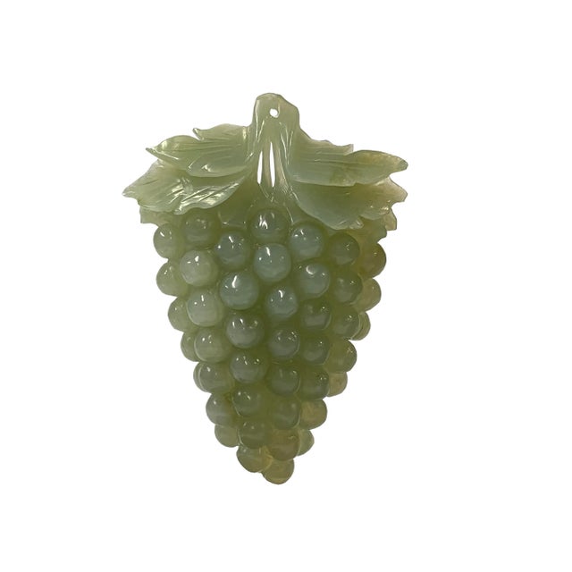 This exquisite Chinese soapstone carving showcases a stunning celadon green translucent hue, depicting a cluster of...