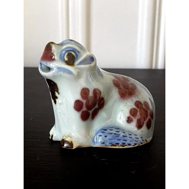 A lovely Korean ceramic water dropper in the form of a sitting dog circa 19th century late Joseon Dynasty. The charming...