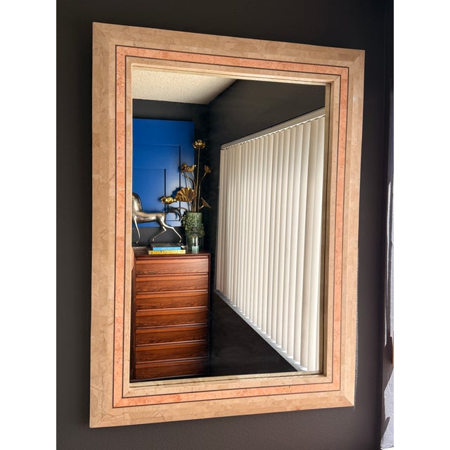 Tessellated fossil coral and pink stone wall mirror with brass trim in the manner of Maitland Smith. Can be hang vertical...